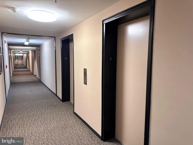 a view of a hallway with wooden shelves