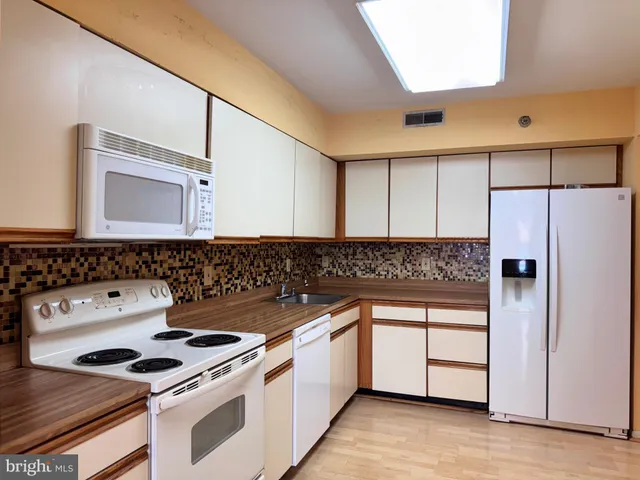 a kitchen with a stove and a refrigerator