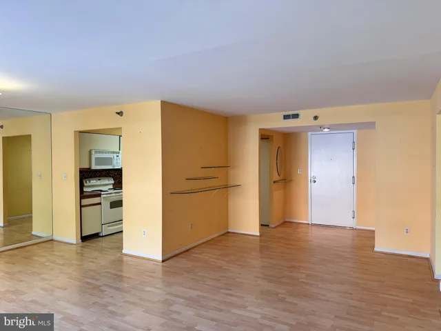 a view of a kitchen with a sink and a refrigerator