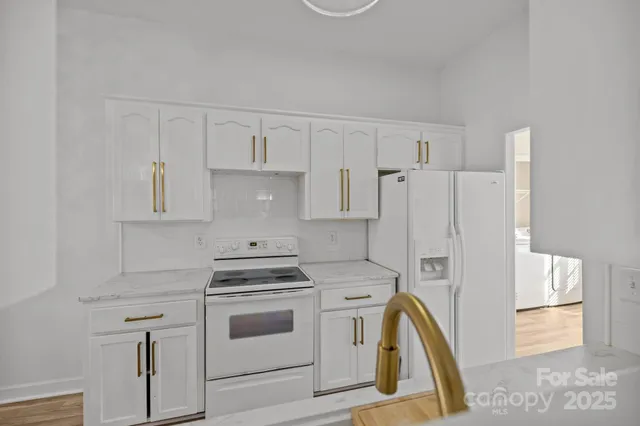 a kitchen with a stove a sink and a refrigerator