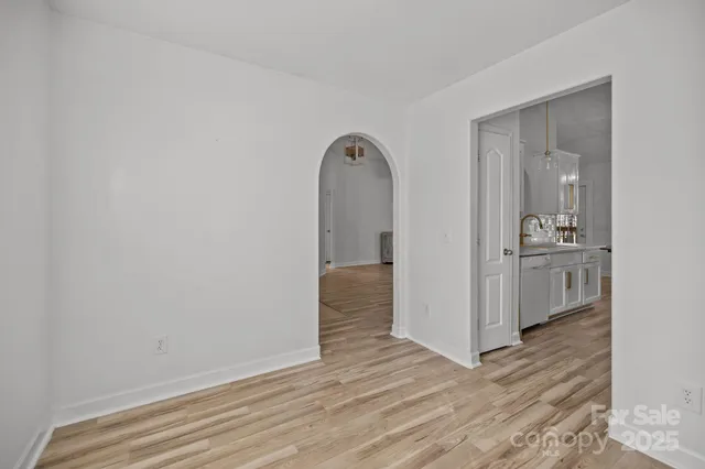 a view of a room with wooden floor and bathroom