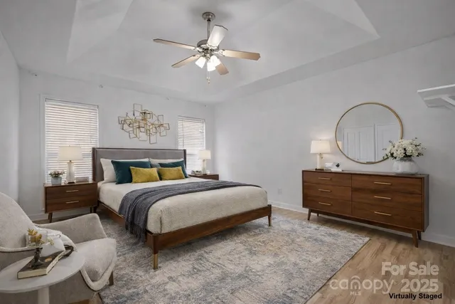 a bedroom with bed and a chandelier