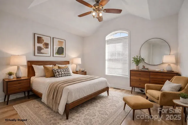 a bedroom with a bed a couch and dresser