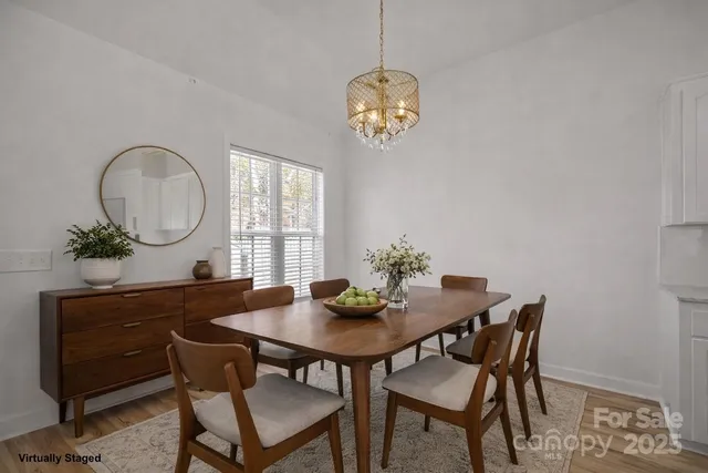 a view of a dining room with a table and chairs