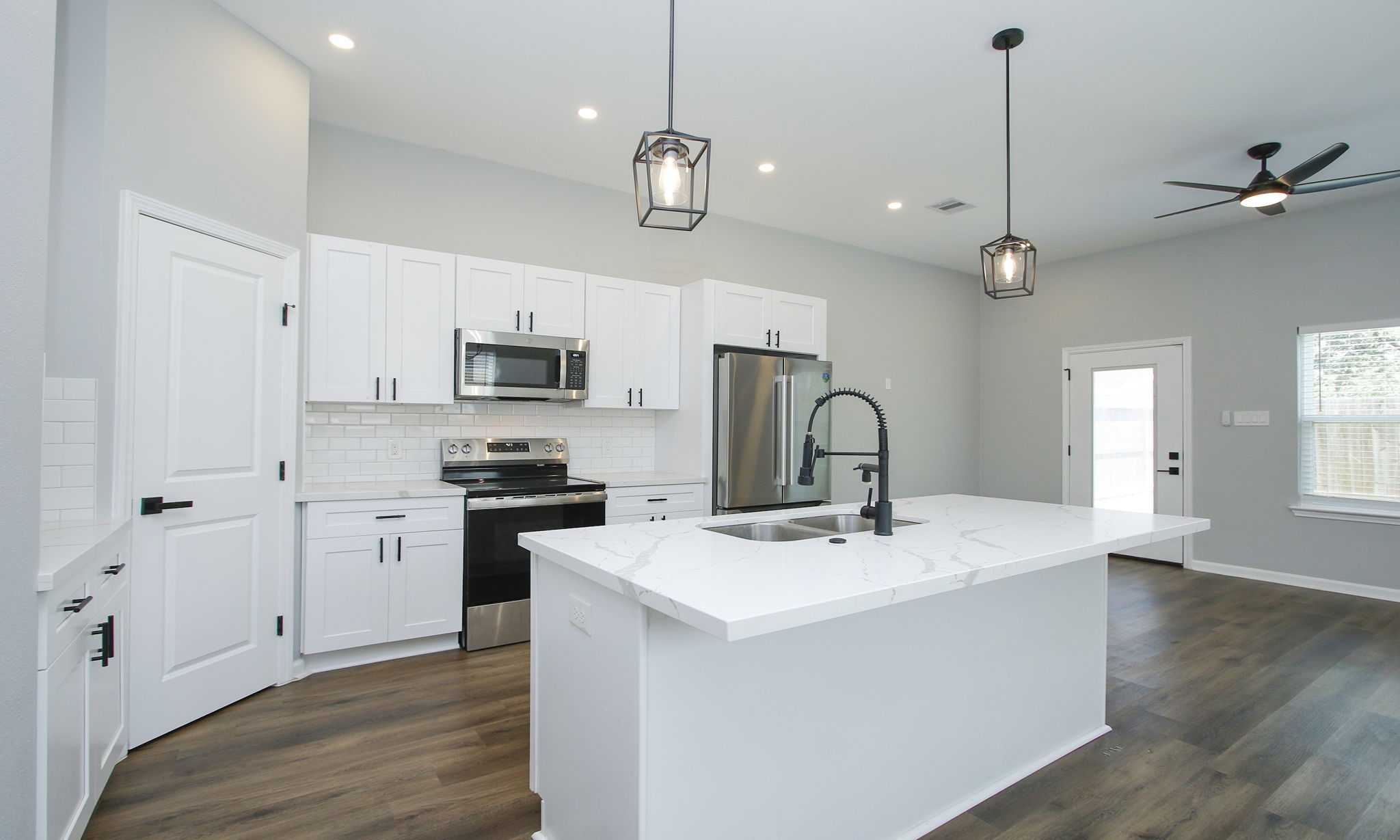 4337 Faulkner Street Houston, TX 77021 - Photo 5 of 39 a kitchen with stainless steel appliances granite countertop a sink a stove a refrigerator and island with wooden floor