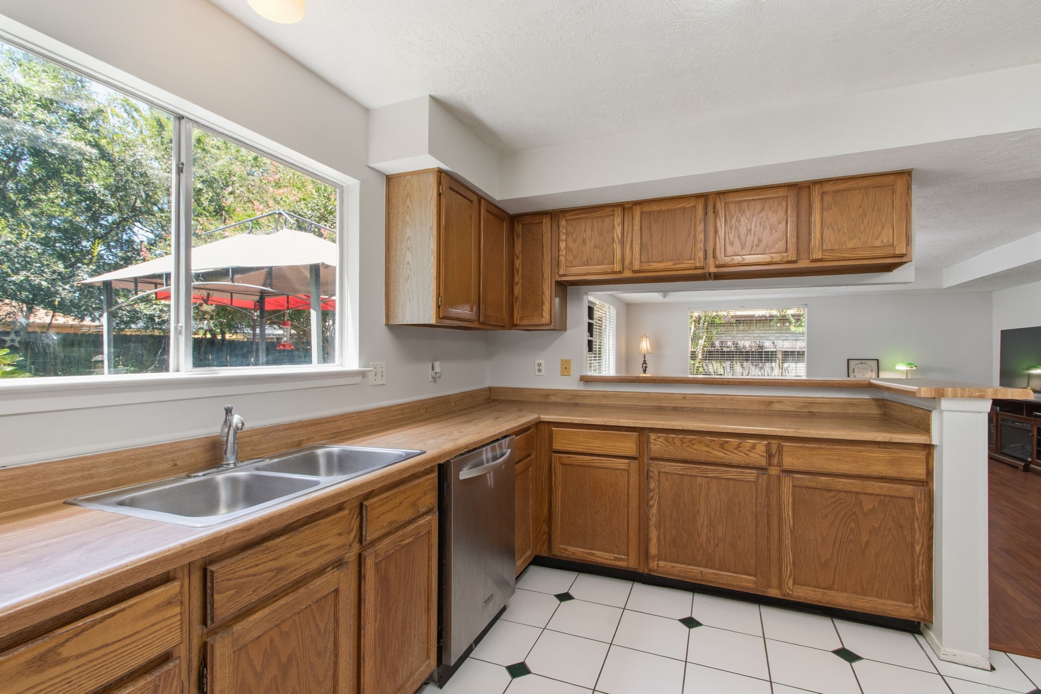 4835 Ingleside Court Spring, TX 77388 - Photo 15 of 50 KITCHEN - Another look at the large kitchen window. The kitchen connects with the family room through the breakfast bar.