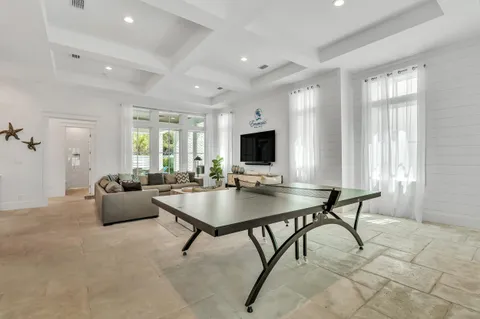 a view of a patio with table and chairs with wooden floor and plants