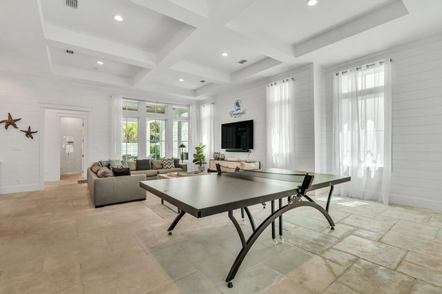 a view of a patio with table and chairs with wooden floor and plants