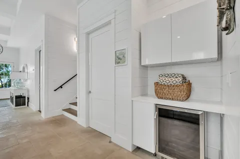 a kitchen with a dining table chairs and a sink