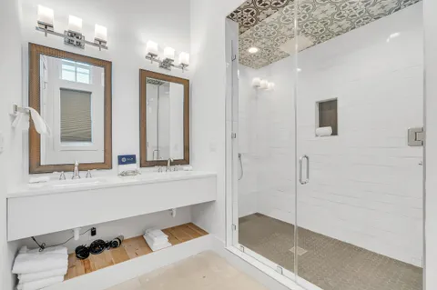 a view of a dining room with furniture large windows and wooden floor