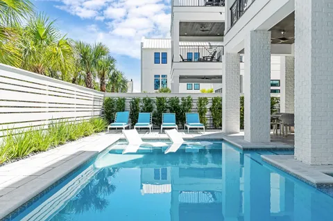 a bath room with a sink and wooden floor