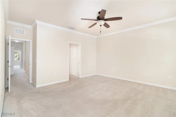 a view of a livingroom with a ceiling fan and entryway