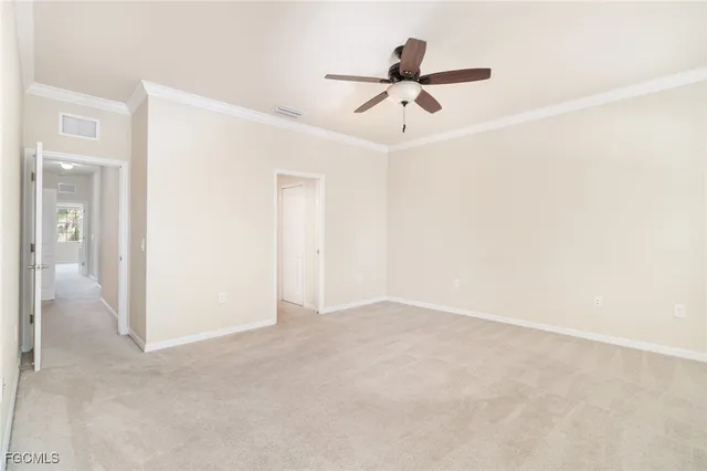 a view of a livingroom with a ceiling fan and entryway