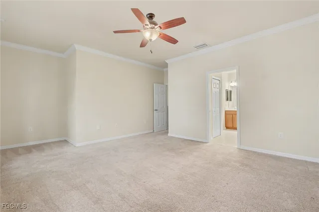 an empty room with chandelier fan