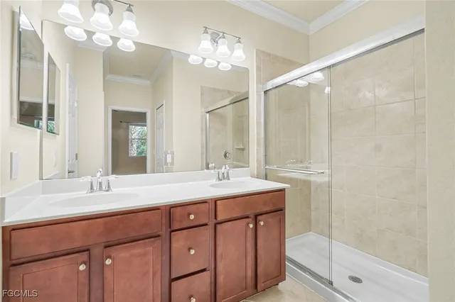 a bathroom with a sink double vanity granite and a mirror