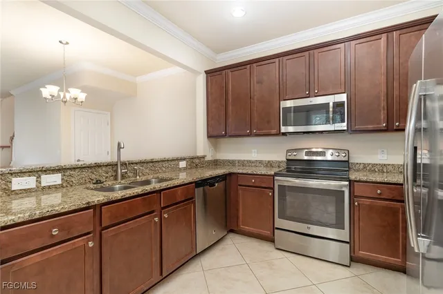 a kitchen with granite countertop a stove microwave and sink