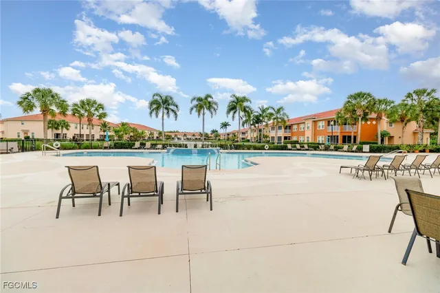 a view of a swimming pool with outdoor seating and plants
