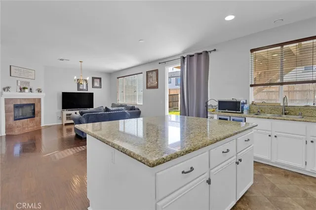 a kitchen with granite countertop a sink and a stove top oven