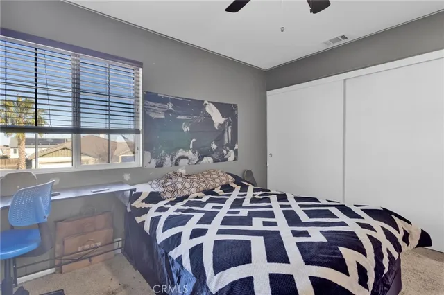 a bedroom with a bed and a window