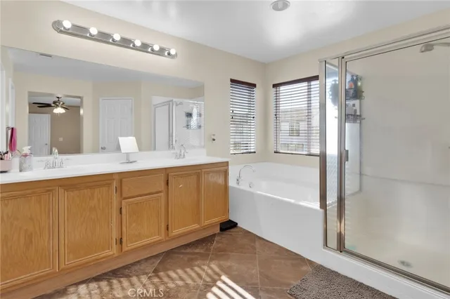 a spacious bathroom with a tub sink and mirror