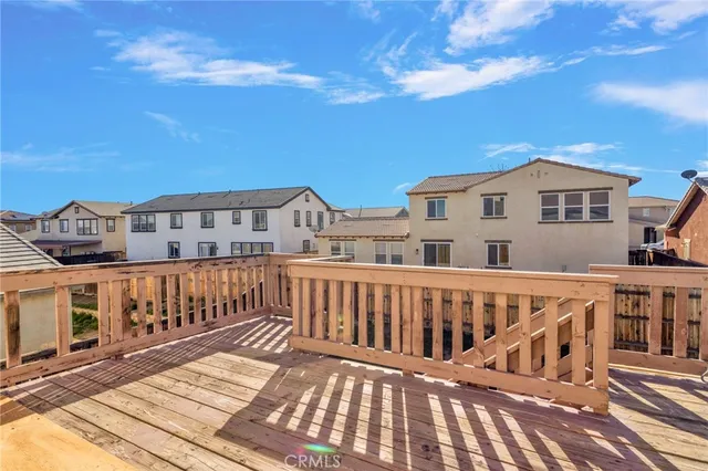 a view of a house with wooden deck