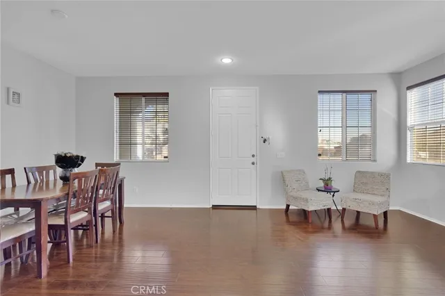 a dining room with furniture and wooden floor