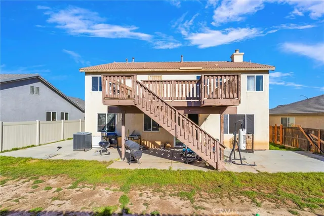 a view of a house with pool and sitting area