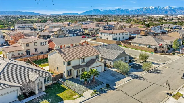 an aerial view of residential houses with outdoor space and parking