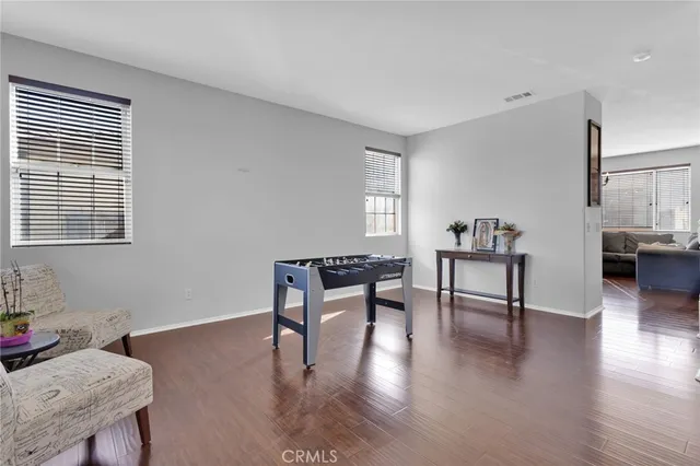 a reading room with furniture and wooden floor