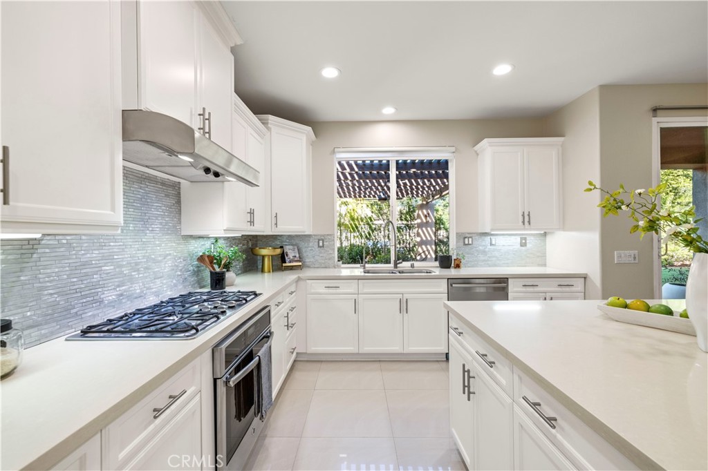 28613 Stonegate Court Valencia, CA 91354 - Photo 13 of 56 a kitchen with a sink stove and cabinets