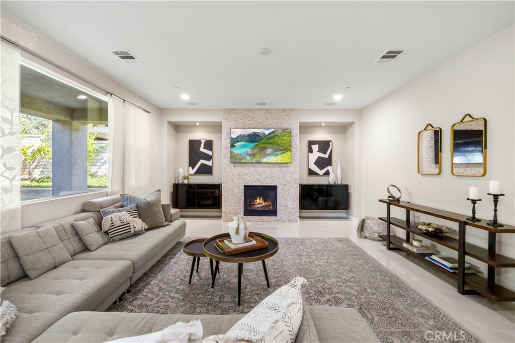28613 Stonegate Court Valencia, CA 91354 - Photo 15 of 56 a living room with furniture a flat screen tv and a fireplace