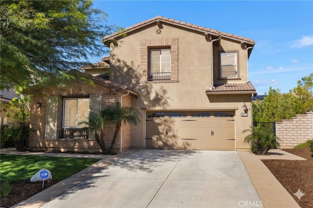28613 Stonegate Court Valencia, CA 91354 - Photo 2 of 56 a front view of a house with a yard and garage