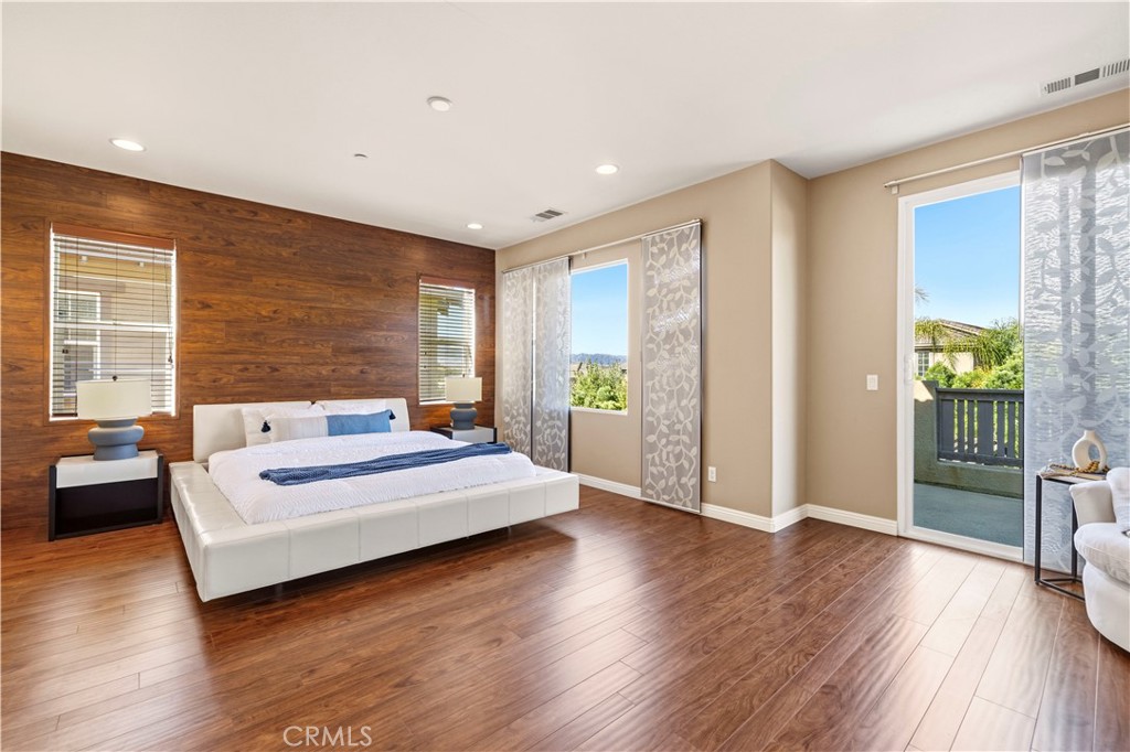 28613 Stonegate Court Valencia, CA 91354 - Photo 24 of 56 a spacious bedroom with a bed and wooden floor