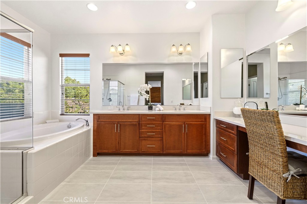 28613 Stonegate Court Valencia, CA 91354 - Photo 26 of 56 a spacious bathroom with a granite countertop tub sink and mirror