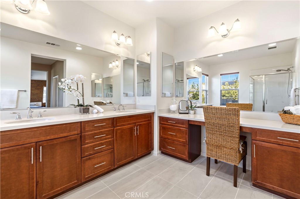 28613 Stonegate Court Valencia, CA 91354 - Photo 27 of 56 a large bathroom with a double vanity sink and a mirror