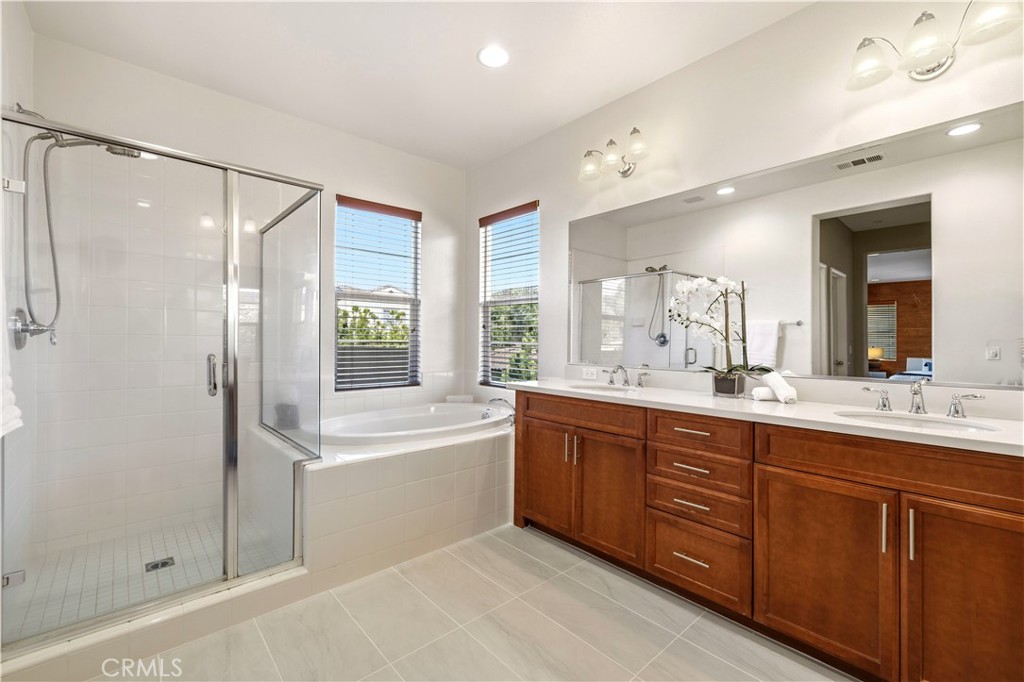 28613 Stonegate Court Valencia, CA 91354 - Photo 28 of 56 a bathroom with a tub sink shower and mirror