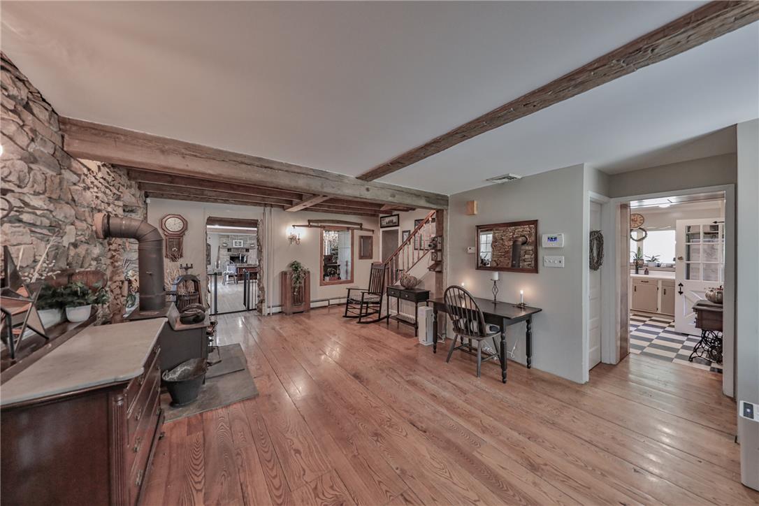 4985 Church View Road Zionsville, PA 18092 - Photo 5 of 7 Exposed wood beams and a rustic stone wall create a charming, cozy living space.