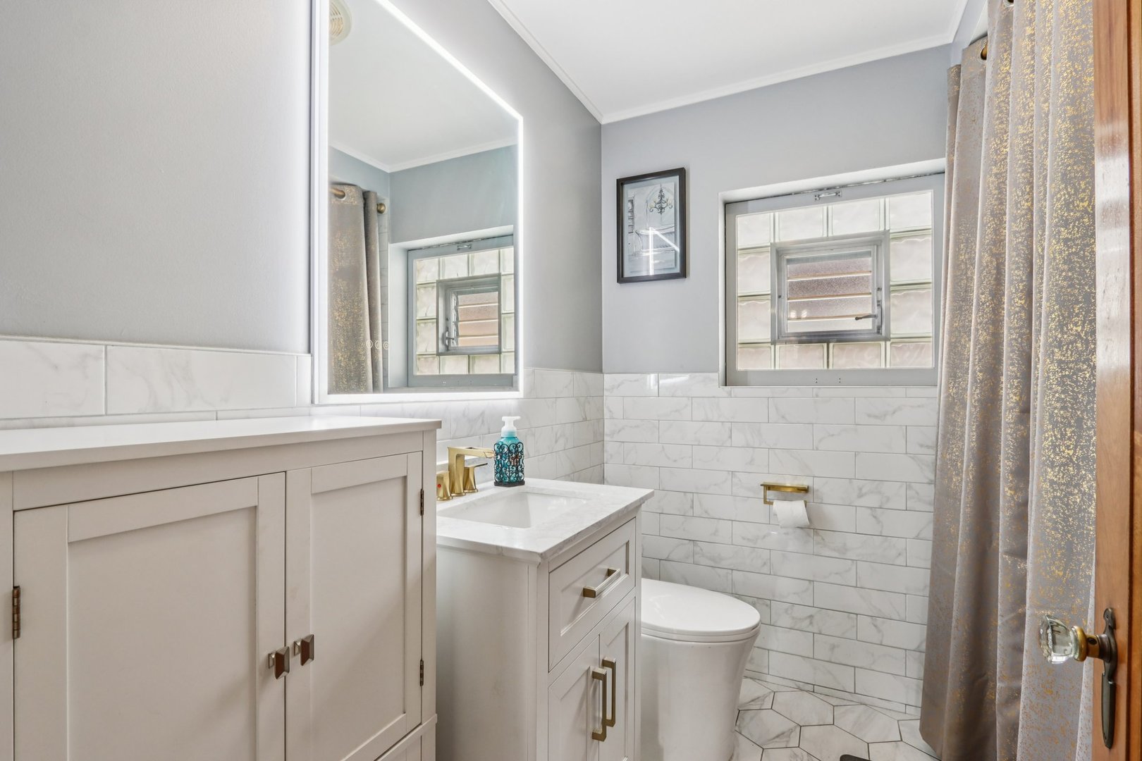 2246 Clinton Avenue Berwyn, IL 60402 - Photo 11 of 20 a bathroom with a toilet sink and mirror