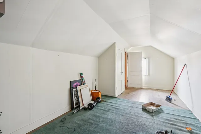 a view of room with wooden floor and stairs
