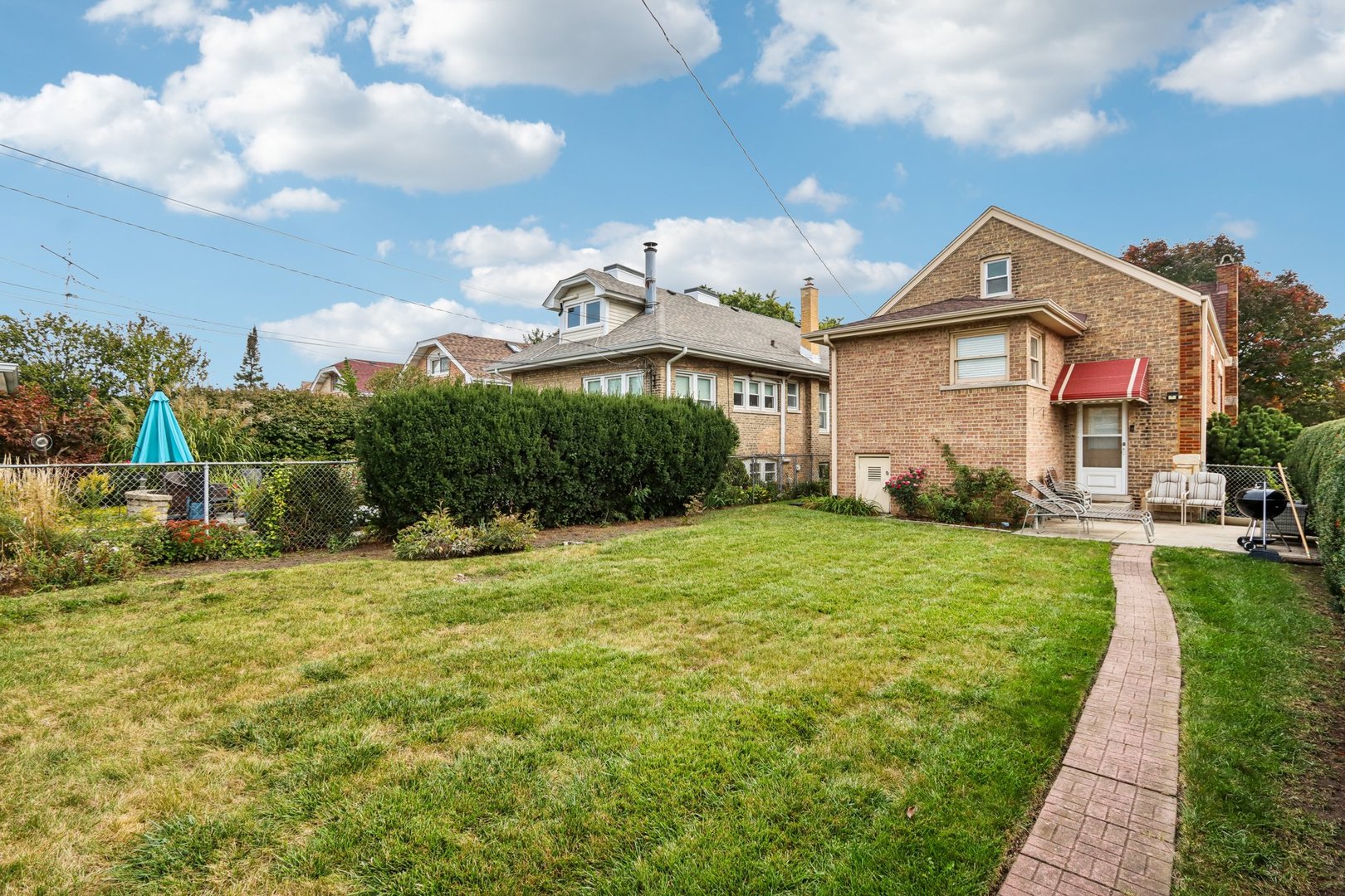2246 Clinton Avenue Berwyn, IL 60402 - Photo 16 of 20 a front view of a house with garden