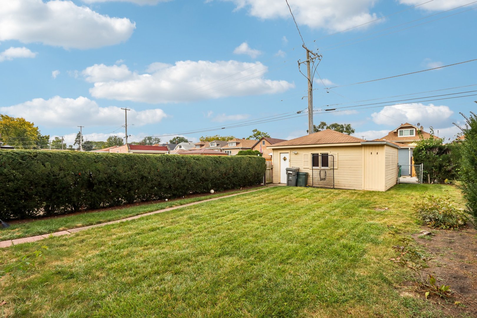 2246 Clinton Avenue Berwyn, IL 60402 - Photo 17 of 20 a front view of a house with a yard