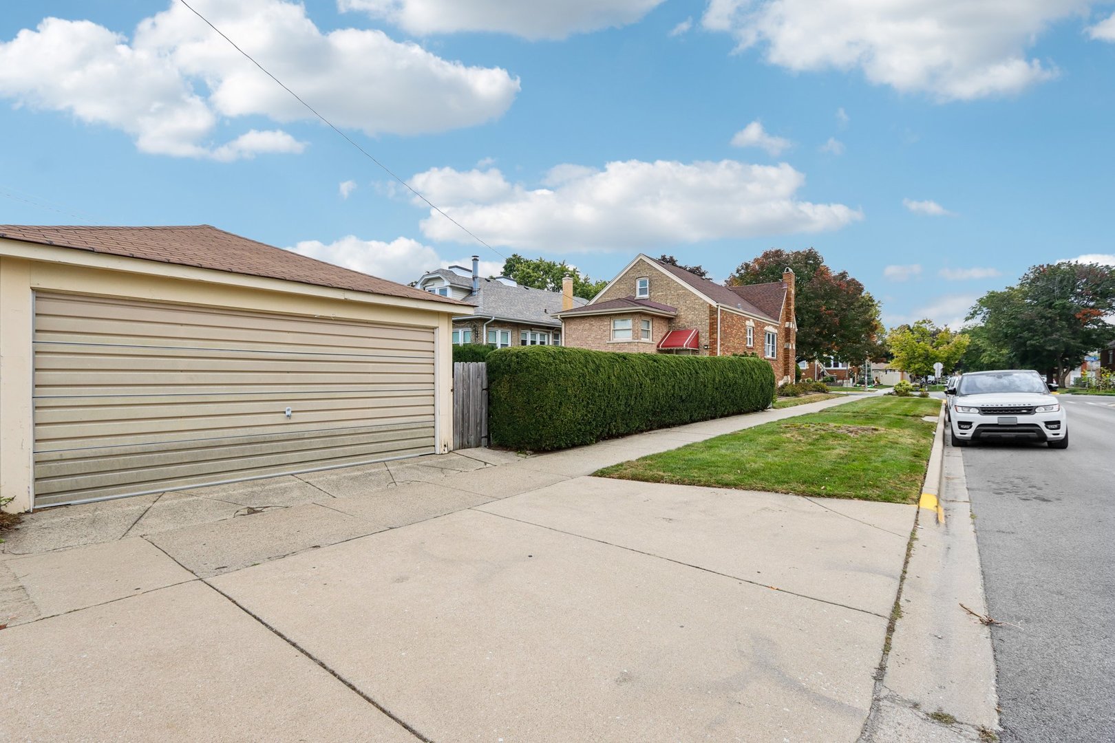 2246 Clinton Avenue Berwyn, IL 60402 - Photo 18 of 20 a view of a white house with a yard and table and chairs