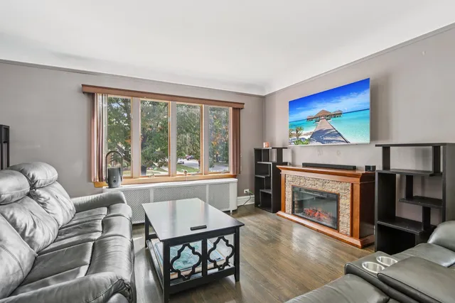 a living room with furniture a window and a fireplace