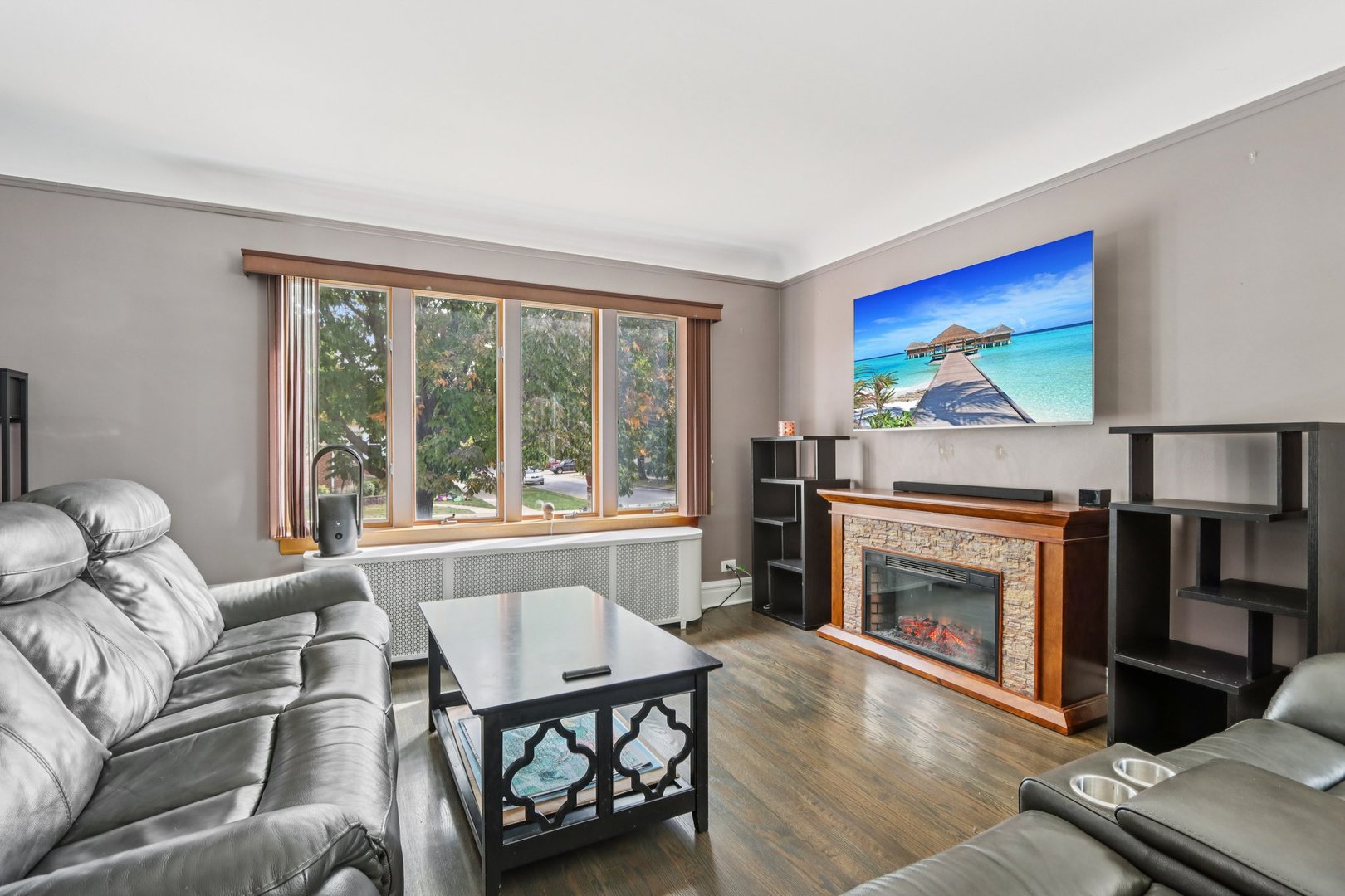 2246 Clinton Avenue Berwyn, IL 60402 - Photo 3 of 20 a living room with furniture a window and a fireplace