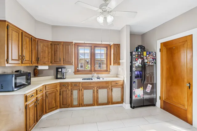 a large kitchen with a large window cabinets and stainless steel appliances