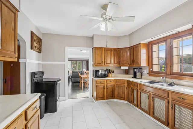 a large kitchen with a large counter top space appliances and cabinets