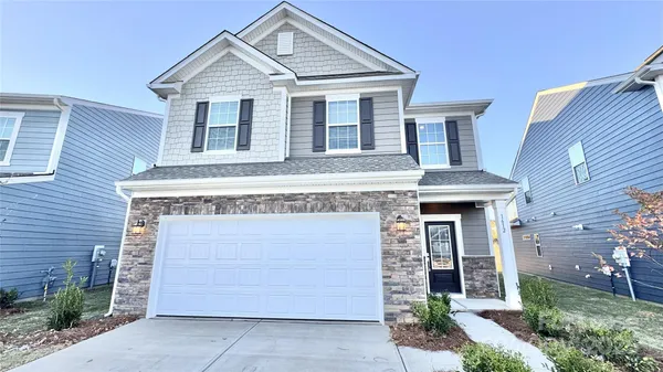 a front view of a house with a garage