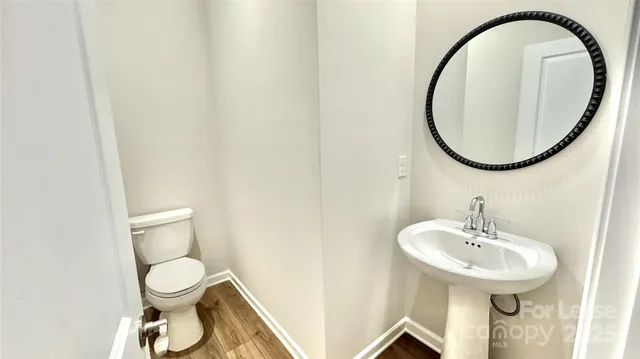 a bathroom with a toilet a sink and a mirror