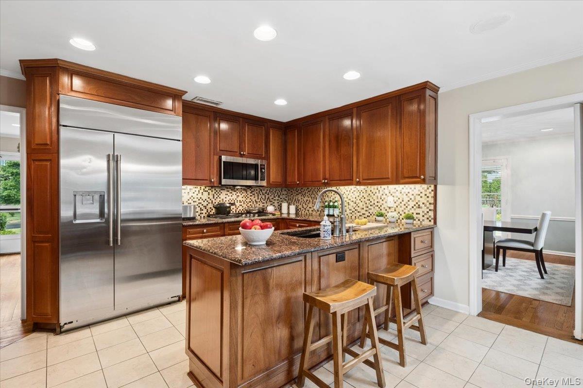 30 Stonehouse Road Scarsdale, NY 10583 - Photo 5 of 24 Chef's kitchen with island and GE Monogram stainless steel appliances.