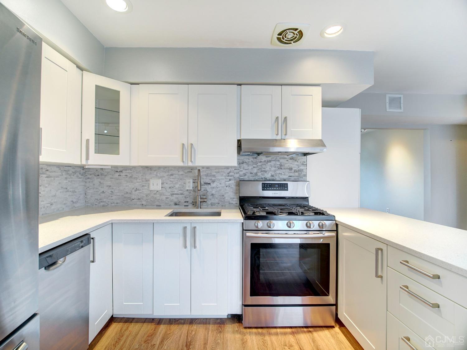 57 Judson Street, Unit 10B Edison, NJ 08837 - Photo 11 of 25 a kitchen with a stove and a sink